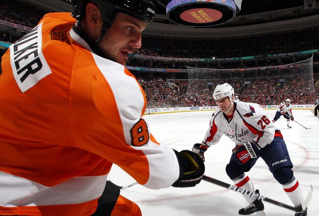 PHILADELPHIA, PA - JANUARY 18: Matt Hendricks #26 of the Washington Capitals lines up Matt Walker #8 of the Philadelphia Flyers for a check during the first period at the Wells Fargo Center on January 18, 2011 in Philadelphia, Pennsylvania. (Photo by Bruce Bennett/Getty Images)