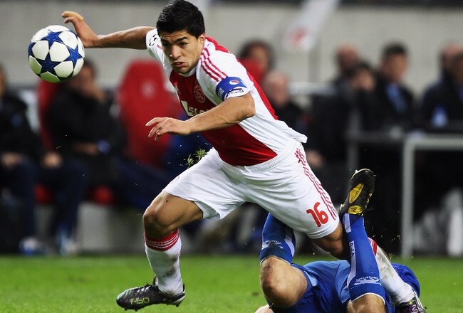 AMSTERDAM, NETHERLANDS - OCTOBER 19:  Luis Suarez of AFC Ajax steps over Stephane Grichting of AJ Auxerre during the UEFA Champions League Group G match between AFC Ajax and AJ Auxerre at the Amsterdam ArenA on October 19, 2010 in Amsterdam, Netherlands.  (Photo by Bryn Lennon/Getty Images)