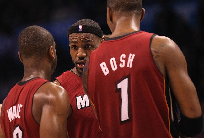 OKLAHOMA CITY, OK - JANUARY 30:  Forward LeBron James #6 talks with Dwyane Wade #3 and Chris Bosh #1 of the Miami Heat during play against the Oklahoma City Thunder at Ford Center on January 30, 2011 in Oklahoma City, Oklahoma.  NOTE TO USER: User expressly acknowledges and agrees that, by downloading and or using this photograph, User is consenting to the terms and conditions of the Getty Images License Agreement.  (Photo by Ronald Martinez/Getty Images)