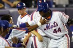 NEW YORK - AUGUST 19:  Lastings Milledge #44 of the New York Mets is congratulated by his teammates on his 8th inning home run against the Colorado Rockies at Shea Stadium August 19, 2006 in the Queens borough of New York City. The Mets defeated the Rockies 7-4.  (Photo by Chris Trotman/Getty Images)