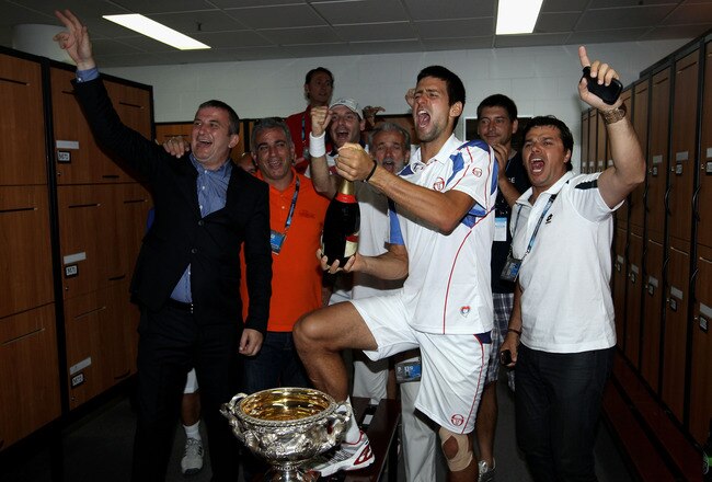 MELBOURNE, AUSTRALIA - JANUARY 30:  Novak Djokovic of Serbia sprays champagne in the players locker room after winning the men's final match against Andy Murray of Great Britain during day fourteen of the 2011 Australian Open at Melbourne Park on January 30, 2011 in Melbourne, Australia.  (Photo by Clive Brunskill/Getty Images)