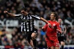 NEWCASTLE UPON TYNE, ENGLAND - DECEMBER 11:  Andy Carroll of Newcastle United competes with Lucas of Liverpool during the Barclays Premier League match between Newcastle United and Liverpool at St James' Park on December 11, 2010 in Newcastle, England.  (Photo by Mark Thompson/Getty Images)