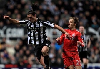 NEWCASTLE UPON TYNE, ENGLAND - DECEMBER 11:  Andy Carroll of Newcastle United competes with Lucas of Liverpool during the Barclays Premier League match between Newcastle United and Liverpool at St James' Park on December 11, 2010 in Newcastle, England.  (Photo by Mark Thompson/Getty Images)