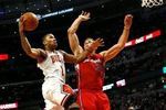 Blake_griffin_tries_to_block_derrick_rose_s_shot_crop_150x100