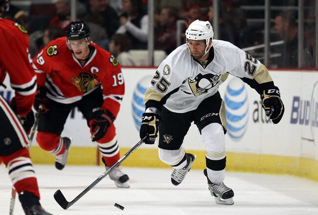 CHICAGO - OCTOBER 01: Max Talbot #25 of the Pittsburgh Penguins skates past Jonathan Toews #19 of the Chicago Blackhawks during a pre-season game at the United Center on October 1, 2010 in Chicago, Illinois. The Blackhawks defeated the Penguins 5-2.  (Photo by Jonathan Daniel/Getty Images)