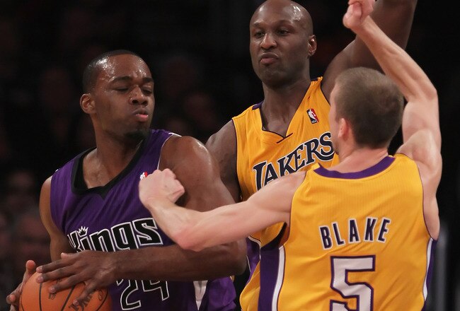 LOS ANGELES, CA - DECEMBER 03:  (L-R) Carl Landry #24 of the Sacramento Kings is defended by Lamar Odom #7 and Steve Blake #5 of the Los Angeles Lakers during the first half at Staples Center on December 3, 2010 in Los Angeles, California. The Lakers defeated the Kings 113-80. NOTE TO USER: User expressly acknowledges and agrees that, by downloading and or using this photograph, User is consenting to the terms and conditions of the Getty Images License Agreement.  (Photo by Jeff Gross/Getty Images)