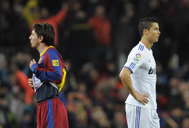 BARCELONA, SPAIN - NOVEMBER 29:  Cristiano Ronaldo of Real Madrid (R) and Lionel Messi of FC Barcelona look on during the La Liga match between Barcelona and Real Madrid at the Camp Nou Stadium on November 29, 2010 in Barcelona, Spain.  Barcelona won the match 5-0.  (Photo by David Ramos/Getty Images)