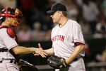 CHICAGO - JULY 21:  Curt Schilling #38 of the Boston Red Sox accepts congratulations from catcher Jason Varitek #33 after a win against the Chicago White Sox July 21, 2005 at U.S. Cellular Field in Chicago, Illinois. The Red Sox defeated the White 6-5.  (Photo by Jonathan Daniel/Getty Images)