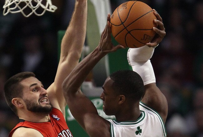 BOSTON, MA - JANUARY 07:  Linas Kleiza #11 of the Toronto Raptors tries to block Rajon Rondo #9 of the Boston Celtics on January 7, 2011 at the TD Garden in Boston, Massachusetts. The Celtics defeated the Raptors 122-102. NOTE TO USER: User expressly acknowledges and agrees that, by downloading and/or using this Photograph, User is consenting to the terms and conditions of the Getty Images License Agreement.  (Photo by Elsa/Getty Images)
