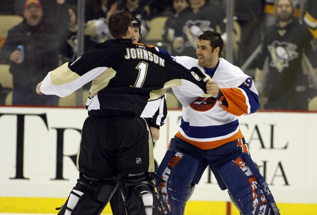 PITTSBURGH, PA - FEBRUARY 02:  Rick DiPietro #39 of the New York Islanders mixes it up against Brent Johnson #1 of the Pittsburgh Penguins at Consol Energy Center on February 2, 2011 in Pittsburgh, Pennsylvania.  The Penguins shut out the Islanders 3-0.  (Photo by Justin K. Aller/Getty Images)