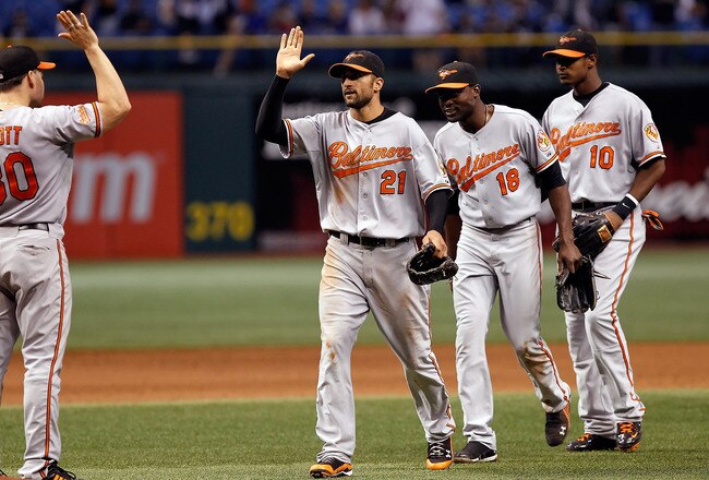 ST. PETERSBURG - SEPTEMBER 27:  Nick Markakis #21, Felix Pie #18 and Adam Jones #10 of the Baltimore Orioles celebrate a victory over the Tampa Bay Rays at Tropicana Field on September 27, 2010 in St. Petersburg, Florida.  (Photo by J. Meric/Getty Images)