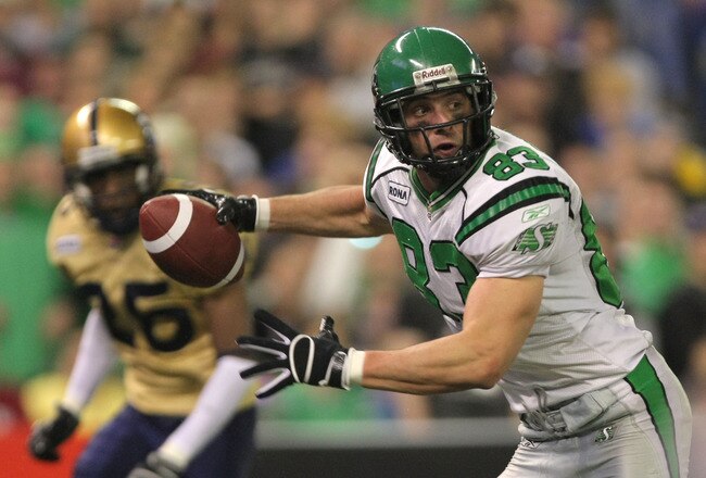 TORONTO, ON - NOVEMBER 25:  Andy Fantuz #83 of the Saskatchewan Rough Riders races to the endzone to score a touchdown in front of Kliff Kingsbury #16 of the Winnipeg Blue Bombers during the fourth quarter in the 95th Grey Cup on November 25, 2007 at the Rogers Centre in Toronto, Ontario, Canada.  (Photo by Harry How/Getty Images)