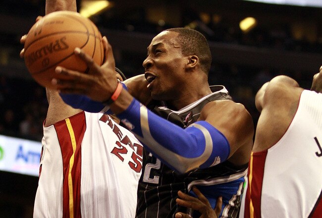 ORLANDO, FL - FEBRUARY 03:  Center Dwight Howard #12 of the Orlando Magic drives against the Miami Heat at Amway Arena on February 3, 2011 in Orlando, Florida. NOTE TO USER: User expressly acknowledges and agrees that, by downloading and or using this photograph, User is consenting to the terms and conditions of the Getty Images License Agreement. (Photo by Marc Serota/Getty Images)