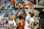 GREENSBORO, NC - DECEMBER 18:  Tyler Zeller #44 and John Henson #31 of the North Carolina Tar Heels block a shot by Jordan Hamilton #3 of the Texas Longhorns at Greensboro Coliseum on December 18, 2010 in Greensboro, North Carolina.  (Photo by Kevin C. Cox/Getty Images)