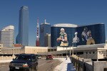 DALLAS, TX - FEBRUARY 5: General view of the downtown skyline with Super Bowl XLV art draped from the Omni Hotel as motorists make their way along on February 5, 2011 in Dallas, Texas. The Green Bay Packers will play the Pittsburgh Steelers in Super Bowl XLV on February 6, 2011 at Cowboys Stadium in Arlington, Texas. (Photo by Joe Robbins/Getty Images)
