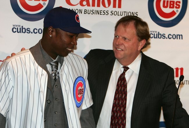 CHICAGO - NOVEMBER 30:  General manager Jim Hendry (R) of the Chicago Cubs introduces Alfonso Soriano #12 during a press conference to announce the sigining of Soriano to an eight year free agent contract November 30, 2006 at the Stadium Club at Wrigley Field in Chicago, Illinois.  (Photo by Chris Chambers/Getty Images)