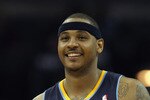 CHARLOTTE, NC - DECEMBER 07:  Carmelo Anthony #15 of the Denver Nuggets watches on against the Charlotte Bobcats during their game at Time Warner Cable Arena on December 7, 2010 in Charlotte, North Carolina.  NOTE TO USER: User expressly acknowledges and agrees that, by downloading and/or using this Photograph, User is consenting to the terms and conditions of the Getty Images License Agreement.  (Photo by Streeter Lecka/Getty Images)