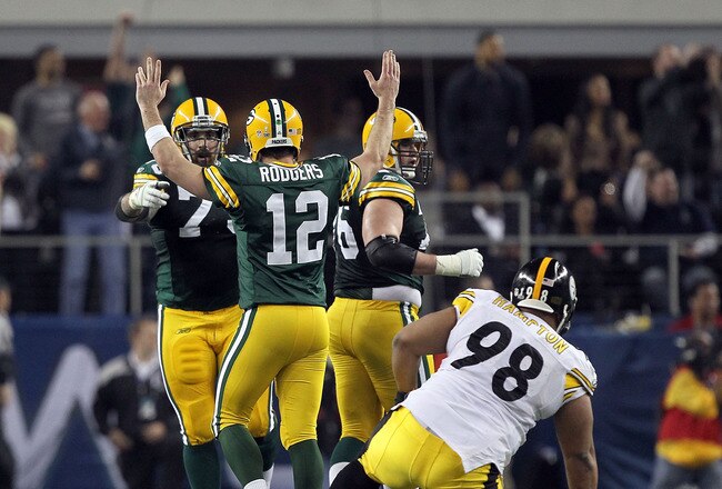 ARLINGTON, TX - FEBRUARY 06: Aaron Rodgers #12 of the Green Bay Packers celebrates late in the game against the Pittsburgh Steelers during Super Bowl XLV at Cowboys Stadium on February 6, 2011 in Arlington, Texas.  (Photo by Al Bello/Getty Images)