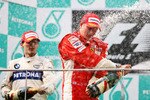 KUALA LUMPUR, MALAYSIA - MARCH 23:  Second placed Robert Kubica (L) of Poland and BMW Sauber celebrates on the podium with race winner Kimi Raikkonen of Finland and Ferrari in the Malaysian Formula One Grand Prix at the Sepang Circuit on March 23, 2008 in Kuala Lumpur, Malaysia.  (Photo by Paul Gilham/Getty Images)