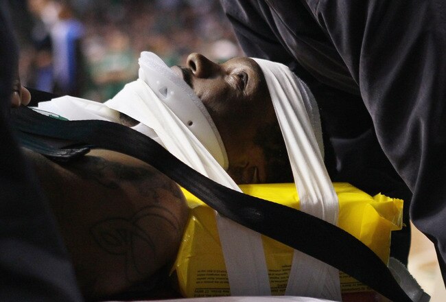 BOSTON, MA - FEBRUARY 06:  Marquis Daniels #8 the Boston Celtics is taken off the court on a stretcher after colliding with Gilbert Arenas #1 of the Orlando Magic on February 6, 2011 at the TD Garden in Boston, Massachusetts.  NOTE TO USER: User expressly acknowledges and agrees that, by downloading and/or using this Photograph, User is consenting to the terms and conditions of the Getty Images License Agreement.  (Photo by Elsa/Getty Images)