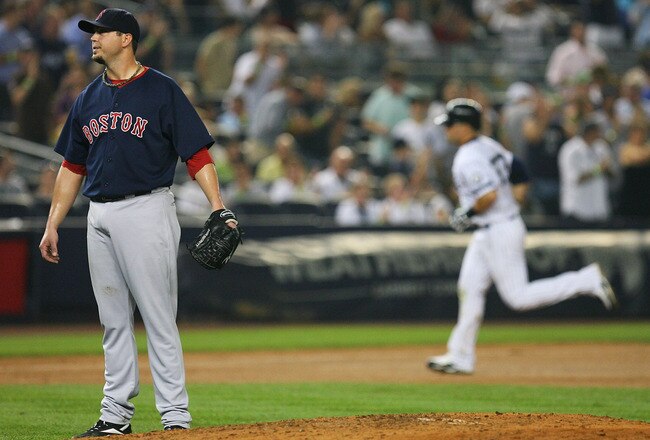 NEW YORK - SEPTEMBER 24:  Josh Beckett #19 of the Boston Red Sox looks on after allowing a two run home run from  Nick Swisher #33 (background) of the New York Yankees in the seventh inning on September 24, 2010 at Yankee Stadium in the Bronx borough of New York City.  (Photo by Andrew Burton/Getty Images)