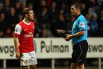 NEWCASTLE UPON TYNE, ENGLAND - FEBRUARY 05:  Jack Wilshire of Arsenal talks to referee Phil Dowd during the Barclays Premier League match between Newcastle United and Arsenal at St James' Park on February 5, 2011 in Newcastle upon Tyne, England.  (Photo by Richard Heathcote/Getty Images)