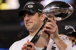 ARLINGTON, TX - FEBRUARY 06:  MVP Aaron Rodgers #12 of the Green Bay Packers holds up The Vince Lombardi Trophy after the Green Bay Packers defeated the Pittsburgh Steelers 31 to 25 in Super Bowl XLV at Cowboys Stadium on February 6, 2011 in Arlington, Texas.  (Photo by Doug Pensinger/Getty Images)