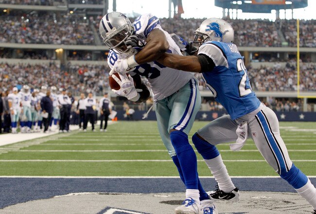 ARLINGTON, TX - NOVEMBER 21:  Dez Bryant #88 of the Dallas Cowboys scores against Chris Houston #23 of the Detroit Lions at Cowboys Stadium on November 21, 2010 in Arlington, Texas.  (Photo by Tom Pennington/Getty Images)