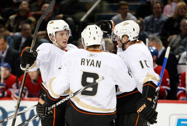 MONTREAL, CANADA - JANUARY 22:  Cam Fowler #4 of the Anaheim Ducks celebrates his first period goal with teammates Bobby Ryan #9 and Corey Perry #10 during the NHL game against the Montreal Canadiens at the Bell Centre on January 22, 2011 in Montreal, Quebec, Canada.  (Photo by Richard Wolowicz/Getty Images)