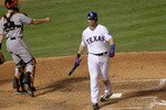 ARLINGTON, TX - OCTOBER 31:  Michael Young #10 of the Texas Rangers reacts to striking out in the seventh inning against the San Francisco Giants as Buster Posey #55 throws to third in Game Four of the 2010 MLB World Series at Rangers Ballpark in Arlington on October 31, 2010 in Arlington, Texas.  (Photo by Stephen Dunn/Getty Images)