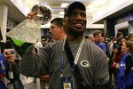 ARLINGTON, TX - FEBRUARY 06: Charles Woodson #21 of the Green Bay Packers celebrates in the locker room with the Vince Lombardi Trophy after winning Super Bowl XLV 31-25 against the Pittsburgh Steelers at Cowboys Stadium on February 6, 2011 in Arlington, Texas.  (Photo by Al Bello/Getty Images)