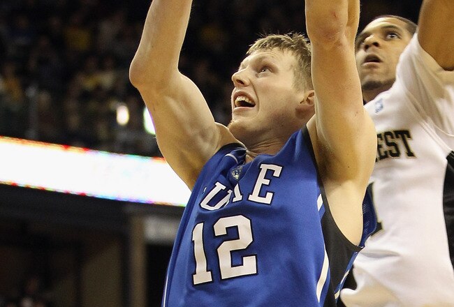 WINSTON SALEM, NC - JANUARY 22:  Kyle Singler #12 of the Duke Blue Devils drives to the basket against Ty Walker #40 of the Wake Forest Demon Deacons at Lawrence Joel Coliseum on January 22, 2011 in Winston Salem, North Carolina.  (Photo by Streeter Lecka/Getty Images)