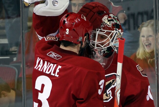 GLENDALE, AZ - FEBRUARY 07:  Ilya Bryzgalov #30  is congratulated by Keith Yandle #3 of the Phoenix Coyotes following a 3-0 shut out against the Colorado Avalanche at the Jobing.com Arena on February 7, 2011 in Glendale, Arizona. The Phoenix Coyotes defeated the Colorado Avalanche 3-0.  (Photo by Bruce Bennett/Getty Images)
