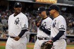 NEW YORK - OCTOBER 20:  (L-R)  CC Sabathia #52, Derek Jeter #2 and Alex Rodriguez #13 of the New York Yankees walk back to the dugout at the end of the top of the fourth inning against the Texas Rangers in Game Five of the ALCS during the 2010 MLB Playoffs at Yankee Stadium on October 20, 2010 in the Bronx borough of New York City.  (Photo by Jim McIsaac/Getty Images)