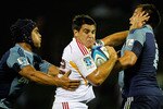 AUCKLAND, NEW ZEALAND - FEBRUARY 11:  Dwayne Sweeney of the Chiefs fends the tackle of Chris Lowrey and Benson Stanley of the Blues during the Super Rugby trial match between the Chiefs and the Blues at Growers Stadium on February 11, 2011 in Auckland, New Zealand.  (Photo by Simon Watts/Getty Images)
