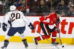 OTTAWA - OCTOBER 22:  Mike Fisher #12 of the Ottawa Senators tries to deke around Ryan Suter #20 of the Nashville Predators during a game at Scotiabank Place on October 22, 2009 in Ottawa, Canada.  (Photo by Phillip MacCallum/Getty Images)