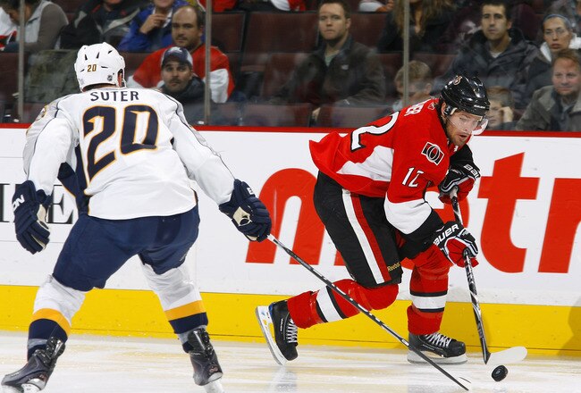 OTTAWA - OCTOBER 22:  Mike Fisher #12 of the Ottawa Senators tries to deke around Ryan Suter #20 of the Nashville Predators during a game at Scotiabank Place on October 22, 2009 in Ottawa, Canada.  (Photo by Phillip MacCallum/Getty Images)