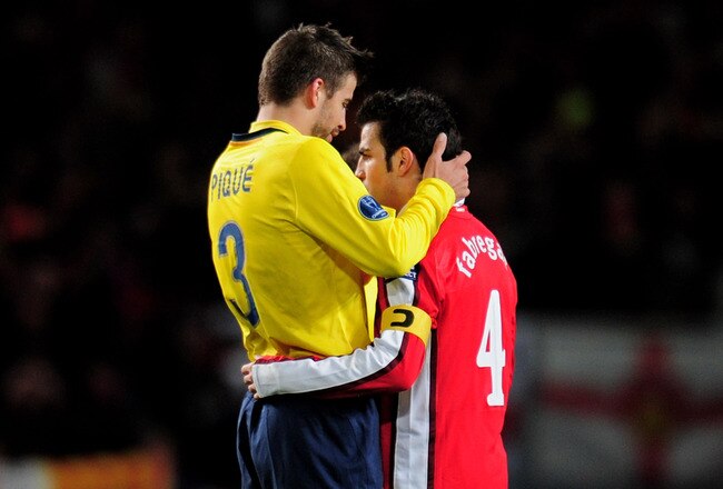 LONDON, ENGLAND - MARCH 31:  Former team mates Gerard Pique (L) of Barcelona and Cesc Fabregas of Arsenal hug each other following their teams' 2-2 draw in the UEFA Champions League quarter final first leg match between Arsenal and FC Barcelona at the Emirates Stadium on March 31, 2010 in London, England.  (Photo by Shaun Botterill/Getty Images)