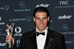ABU DHABI, UNITED ARAB EMIRATES - FEBRUARY 07:  Laureus World Sportsman of the Year Rafael Nadal poses with his trophy at the winners photocall at the 2011 Laureus World Sports Awards at the Emirates Palace on February 7, 2011 in Abu Dhabi, United Arab Emirates.  (Photo by Gareth Cattermole/Getty Images for Laureus)