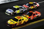 DAYTONA BEACH, FL - FEBRUARY 12:  Kurt Busch, driver of the #22 Shell/Pennzoil Dodge, Jimmie Johnson, driver of the #48 Lowe's Chevrolet, Jamie McMurray, driver of the #1 Bass Pro Shops Chevrolet, and Greg Biffle, driver of the #16 3M Ford, race during the NASCAR Budweiser Shootout at Daytona International Speedway on February 12, 2011 in Daytona Beach, Florida.  (Photo by John Harrelson/Getty Images for NASCAR)