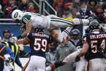 CHICAGO, IL - DECEMBER 26: Dustin Keller #81 of the New York Jets goes airbourne over Pisa Tinoisamoa #59 of the Chicago Bears for a first down at Soldier Field on December 26, 2010 in Chicago, Illinois. The Bears defeated the Jets 38-34. (Photo by Jonathan Daniel/Getty Images)