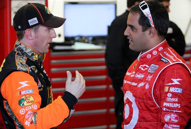 DAYTONA BEACH, FL - FEBRUARY 11:  Jamie McMurray, driver of the #1 Bass Pro Shops Chevrolet, speaks in the garage area with Juan Pablo Montoya, driver of the #42 target Chevrolet, during practice for the NASCAR Budweiser Shootout at Daytona International Speedway on February 11, 2011 in Daytona Beach, Florida.  (Photo by Nick Laham/Getty Images)
