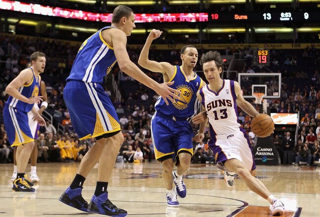 PHOENIX, AZ - FEBRUARY 10:  Steve Nash #13 of the Phoenix Suns drives the ball past Stephen Curry #30 of the Golden State Warriors during the NBA game at US Airways Center on February 10, 2011 in Phoenix, Arizona.  NOTE TO USER: User expressly acknowledges and agrees that, by downloading and or using this photograph, User is consenting to the terms and conditions of the Getty Images License Agreement.  (Photo by Christian Petersen/Getty Images)