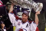 9 Jun 2001:  Peter Forsberg #21 of the Colorado Avalanche raises the Stanley Cup in Denver, Coloardo after losing his spleen earlier, during the Western Conference Finals series, in pursuit of the 2001 NHL Stanley Cup Championship.  DIGITAL IMAGE Mandatory Credit: Brian Bahr/ALLSPORT
