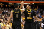 SYRACUSE, NY - MARCH 27:  Kevin Jones #5 and Da'Sean Butler #1 of the West Virginia Mountaineers celebrate a play in the second half against the Kentucky Wildcats during the east regional final of the 2010 NCAA men's basketball tournament at the Carrier Dome on March 27, 2010 in Syracuse, New York.  West Virginia won 73-66.(Photo by Jim McIsaac/Getty Images)