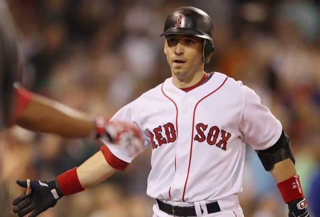 BOSTON - SEPTEMBER 08:  Marco Scutaro #16 of the Boston Red Sox is congratulated after he hit a two run homer against the Tampa Bay Rays on September 8, 2010 at Fenway Park in Boston, Massachusetts.  (Photo by Elsa/Getty Images)