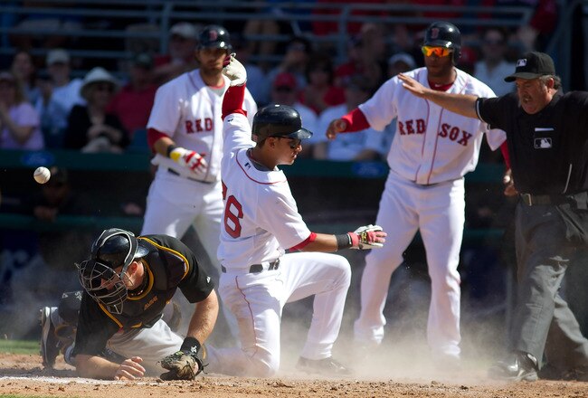 FORT MYERS, FL - MARCH 13:  Catcher Erik Kratz #67 of the Pittsburgh Pirates  cannot handle the throw as infielder Jose Iglesias #76 of the Boston Red Sox scores during a Grapefruit League Spring Training Game at City of Palms Park on March 13, 2010 in Fort Myers, Florida.  (Photo by J. Meric/Getty Images)