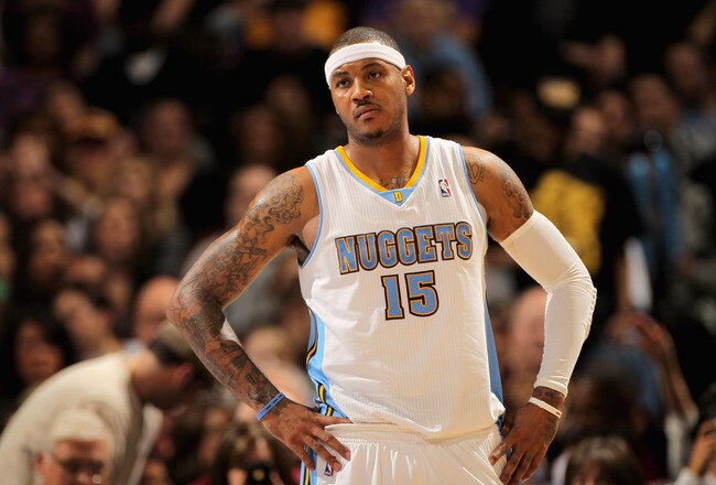 DENVER, CO - JANUARY 21:  Carmelo Anthony #15 of the Denver Nuggets looks on during a break in the action against the Los Angeles Lakers at the Pepsi Center on January 21, 2011 in Denver, Colorado. The Lakers defeated the Nuggets 107-97. NOTE TO USER: User expressly acknowledges and agrees that, by downloading and or using this photograph, User is consenting to the terms and conditions of the Getty Images License Agreement.  (Photo by Doug Pensinger/Getty Images)
