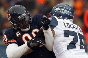 CHICAGO, IL - JANUARY 16:  Julius Peppers #90 of the Chicago Bears is blocked by Sean Locklear #75 of the Seattle Seahawks in the 2011 NFC divisional playoff game at Soldier Field on January 16, 2011 in Chicago, Illinois.  (Photo by Jonathan Daniel/Getty Images)