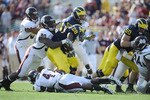 JACKSONVILLE, FL - JANUARY 01:  Pernell McPhee #90 of Mississippi State tackles Fitzgerald Toussaint # 28 of the Michigan Wolverines during the Gator Bowl at EverBank Field on January 1, 2011 in Jacksonville, Florida  (Photo by Rick Dole/Getty Images)